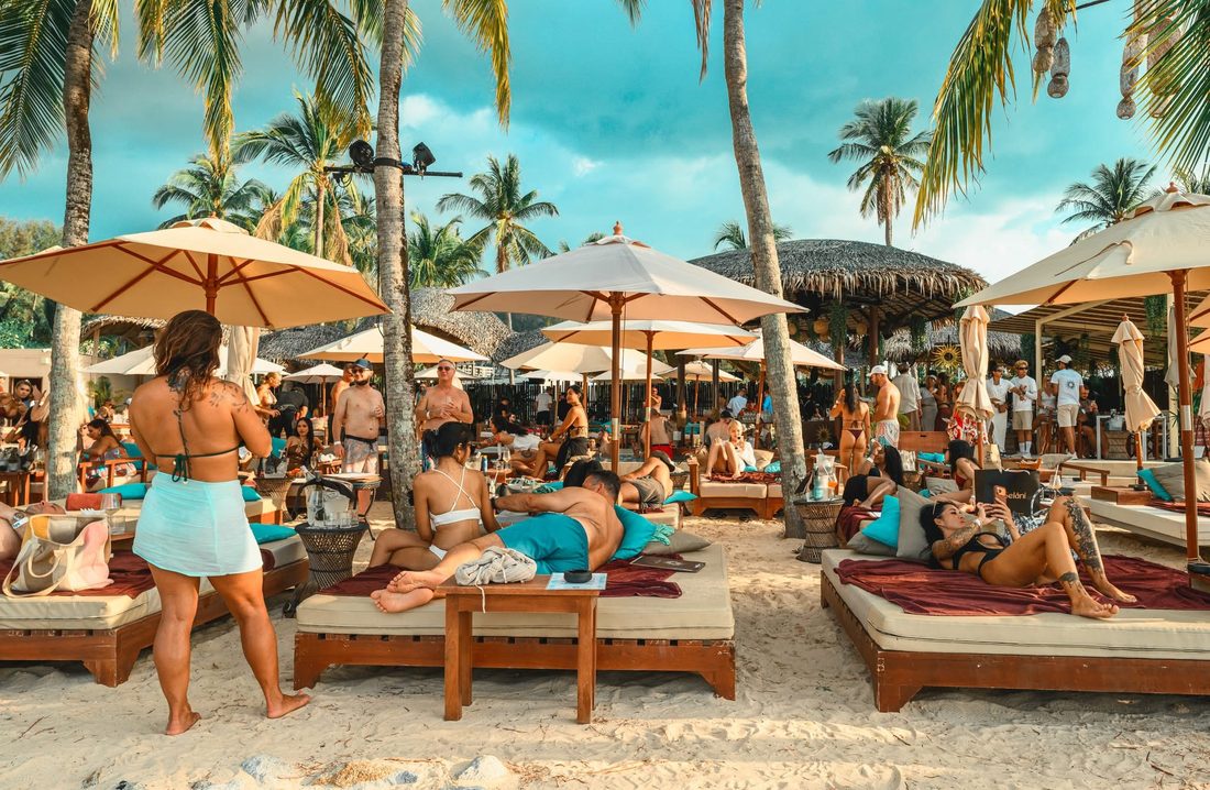 Guests relaxing on sun beds at Carpe Diem Beach Club, Bangtao Beach, Phuket